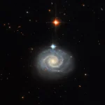 This NASA Hubble Space Telescope image features a bright spiral galaxy known as MCG-01-24-014, which is located about 275 million light-years from Earth.