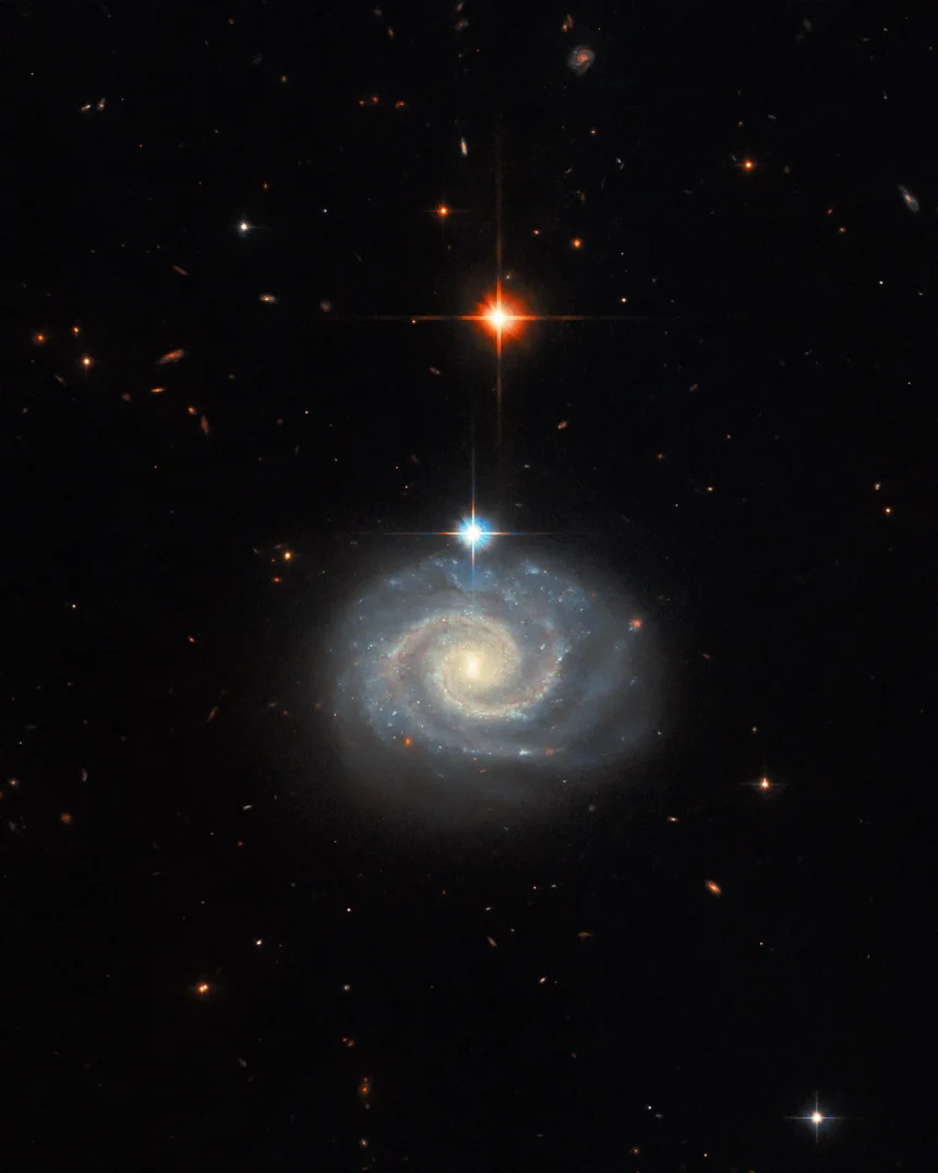 This NASA Hubble Space Telescope image features a bright spiral galaxy known as MCG-01-24-014, which is located about 275 million light-years from Earth.