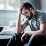 Unpleasant,Pain.,Sad,Unhappy,Handsome,Man,Sitting,On,The,Sofa