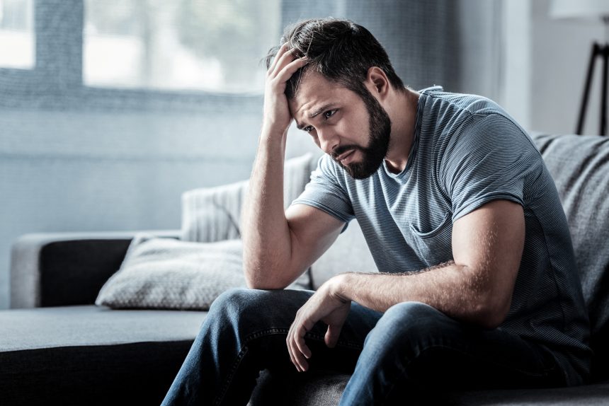 Unpleasant,Pain.,Sad,Unhappy,Handsome,Man,Sitting,On,The,Sofa