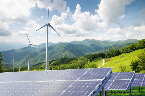 Solar,Panels,With,Wind,Turbines,Against,Mountanis,Landscape,Against,Blue